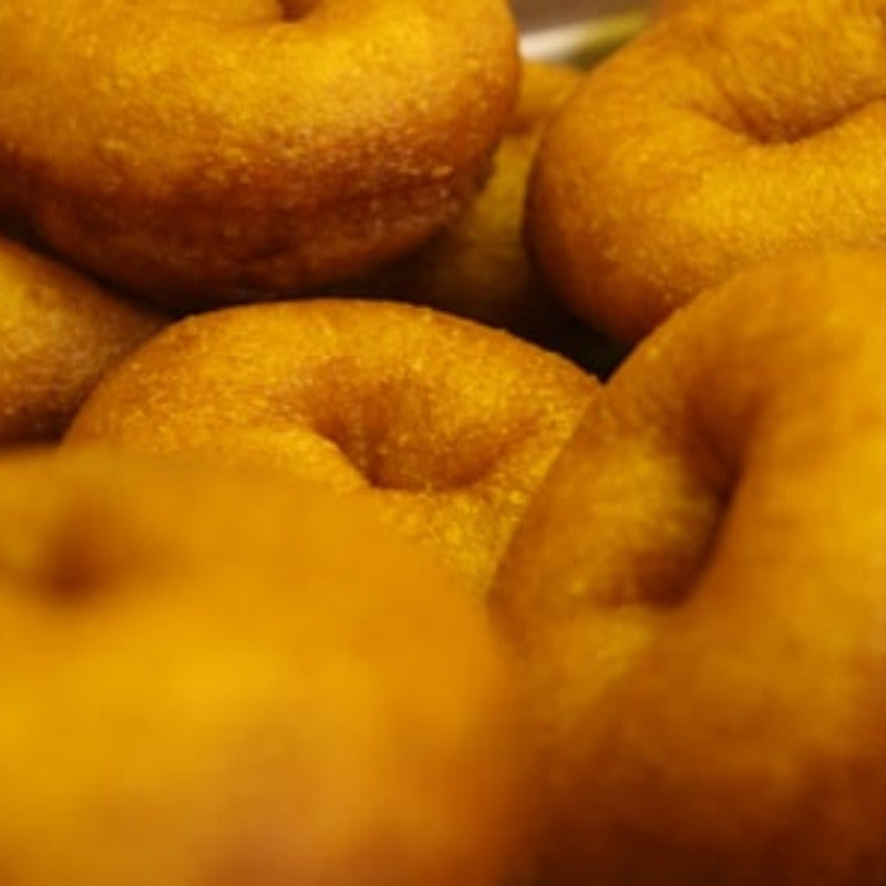 a close up picture of plain Lil' Orbits donuts, waiting to be dusted with the customers topping of choice