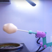 picture of brightly colored robot arm with cotton candy on it, inside a Sweet Robo Model VX Cotton Candy Vending Machine